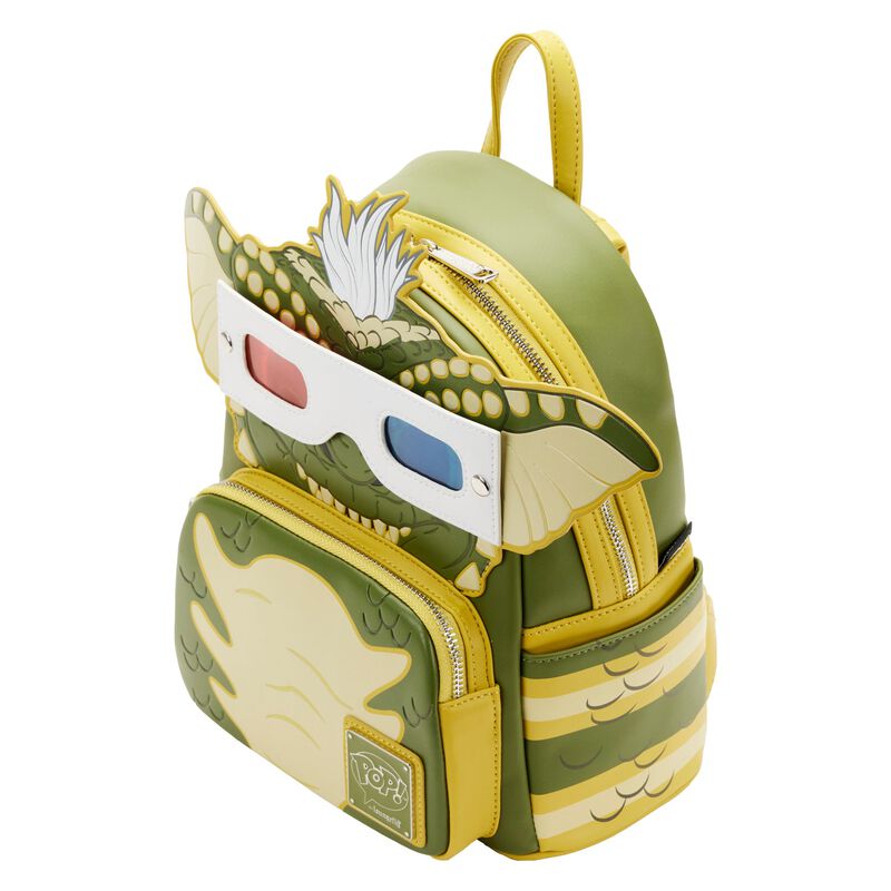 This Gremlins Stripe Mini Backpack by Blue Dog Posters is a green and yellow masterpiece designed to resemble a cartoon creature with large ears and white hair. Featuring 3D glasses on its face and a zippered front pocket, it’s a true collector's item reminiscent of Funko Pop figures.