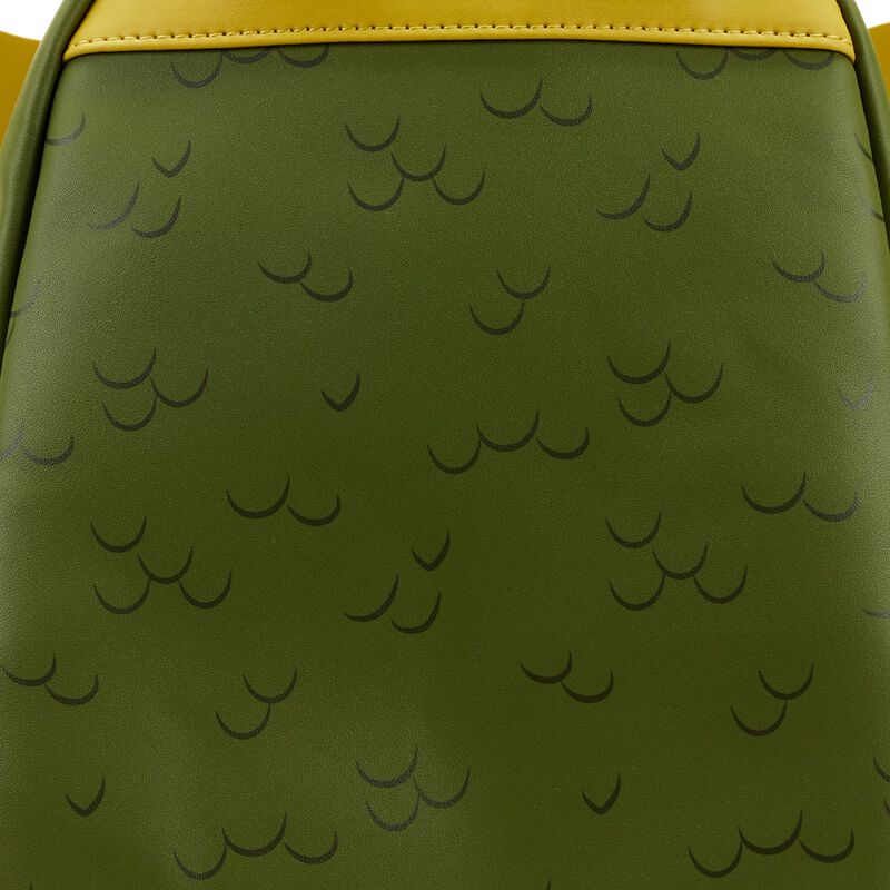 Close-up of a textured, green surface featuring a pattern of small black crescent shapes. This material appears to be part of the Gremlins Stripe Mini Backpack by Blue Dog Posters, bordered by a yellowish strip at the top, indicating it might be an accessory component.
