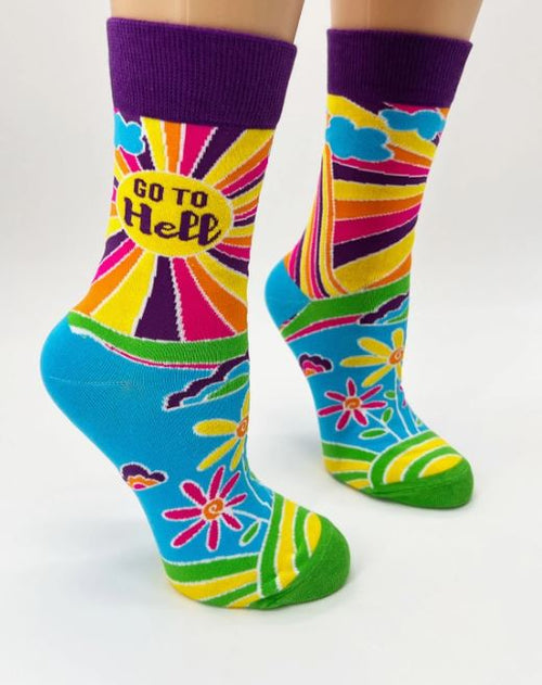 The Go to Hell Socks Ladies by Blue Dog Posters are a stylish and comfortable pair of brightly colored socks. Featuring a vibrant design with rainbows, flowers, and clouds against a white background, these socks have green toes and heels. One sock proudly displays the text "Go to Hell" within a yellow oval on the calf.