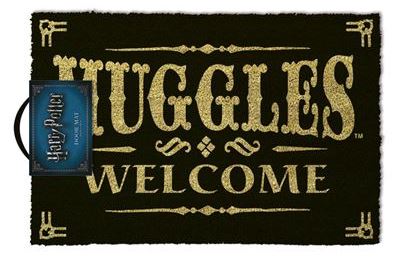 A black coir door mat with gold lettering that reads "Muggles Welcome." The doormat has a worn texture, and there is a small product tag attached indicating it belongs to the Harry Potter - Muggles Welcome by MTV.