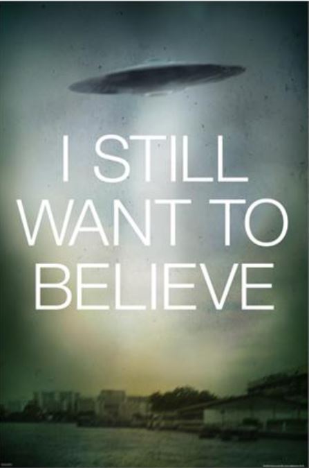 MTV 352's "X Files Still Want to Believe" poster features a blurred image of a flying saucer-shaped UFO in the sky above a cityscape, with large white text reading "I STILL WANT TO BELIEVE" at the center. The background has a green and grey gradient, creating a mysterious atmosphere that makes it an ideal addition to any Movies & TV collection or as a TV show poster.