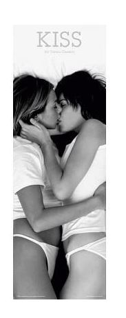 Black and white photo of two people wearing white t-shirts and underwear, lying down while kissing each other. Text at the top reads "KISS." This intimate scene would make a striking addition to any rock poster collection. The "Kiss" by Blue Dog Posters truly captures the essence of romantic moments with a rock n' roll twist.