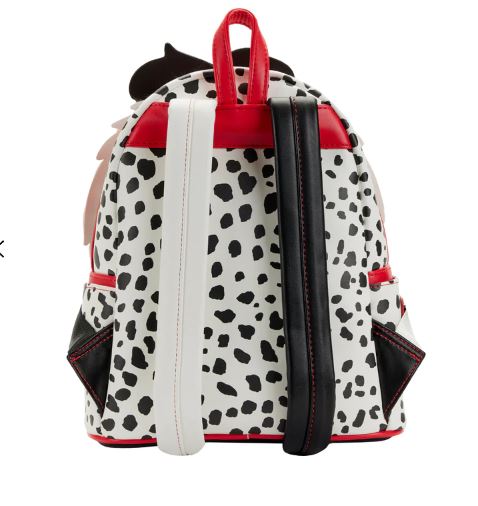 The Blue Dog Posters 101 Dalmatians Cruella Mini Backpack features a black and white Dalmatian print. It is equipped with one red, one white, and one black vertical strap on the back. The edges of this mini backpack include red zippers and black triangular accents highlighted with red stitching.