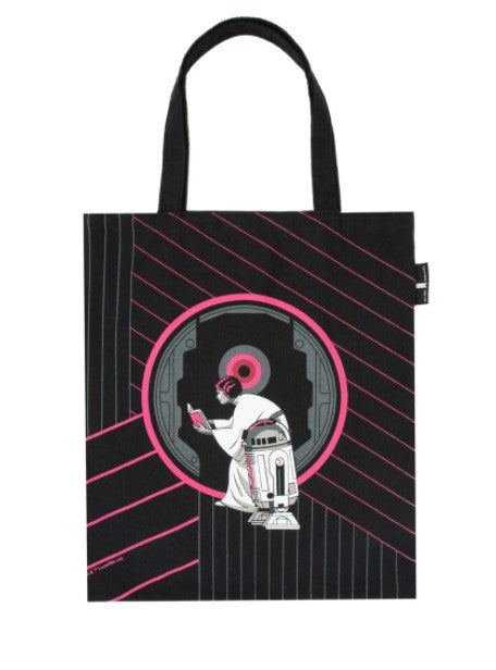 A Blue Dog Posters Out of Print Read Leia Tote featuring a graphic of a robot resembling R2-D2 from Star Wars, interacting with a circular futuristic panel. The design includes pink accents, with lines radiating from the circle, giving it a techno vibe. Part of our Giftware Collection, the bag has black handles.