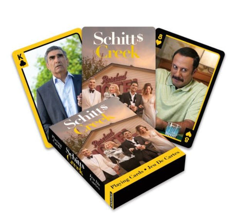 Box of "Schitts Creek Playing Cards" by Blue Dog Posters showcasing unique designs: the King card features a serious man in a suit, while the 8 card depicts a smiling man in a striped shirt. The box itself displays images of the show's cast standing in front of the Rosebud Motel, making it an ideal deck for fans of "Schitt's Creek.