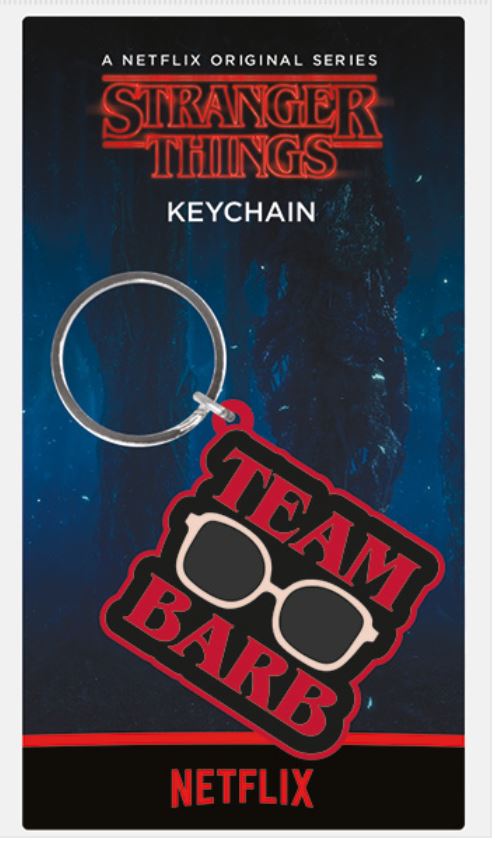 A **Stranger Things Rubber Key Chain - Team Barb** by **Blue Dog Posters** with the text "Team Barb" in red and white letters, featuring a pair of white-framed glasses. The keychain is attached to packaging that displays the logo "Stranger Things" and the text "A Netflix Original Series" and "KEYCHAIN." Perfect for your gifts collection!