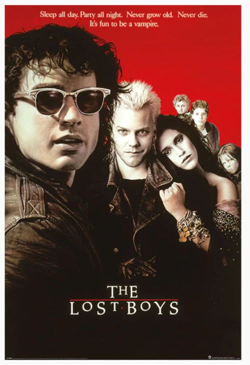 The MTV 410 Hit Movie Poster for "The Lost Boys" features a red and black design with the central figure wearing sunglasses and a leather jacket, exuding edgy cool. The tagline reads: "Sleep all day. Party all night. Never grow old. Never die. It's fun to be a vampire.