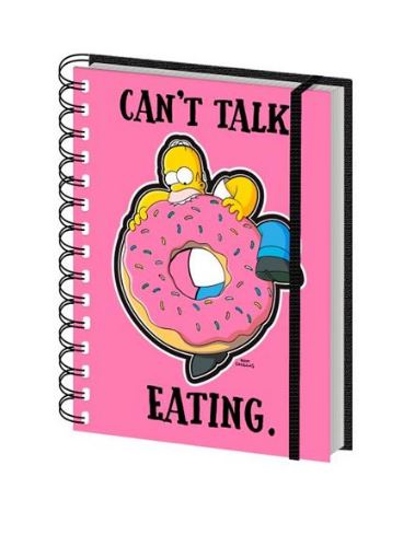 A premium pink spiral notebook with a black elastic band. The cover features a cartoon character holding a large pink donut with sprinkles, and the text reads "CAN'T TALK. EATING." This delightful piece makes for perfect stationery gifts from Blue Dog Posters called "The Simpsons Can't Talk Eating Notebook.