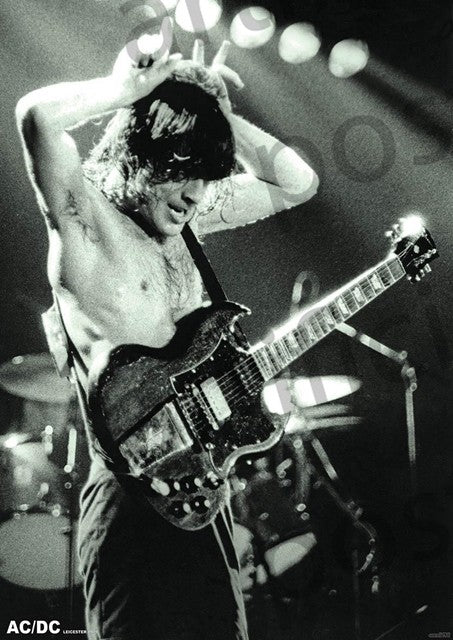 Black and white photo of an electric guitarist performing on stage. The shirtless musician stands with arms up, hands gripping the guitar's neck and headstock. Stage lights illuminate the scene from above, and a drum set is visible in the background—perfect for any rock poster in your music collection.
Replacement:
AC/DC ANGUS YOUNG - 1979 by MUS 326