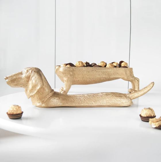 The Dachshund DOG Bowl gold by Blue Dog Posters, shaped like a dachshund with a textured finish, adds charm as it holds chocolates and decorates your table—making it a unique accent for any room.