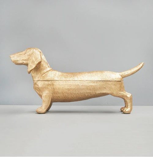 The Blue Dog Posters Dachshund DOG Bowl gold is a charming decorative piece for your home, featuring a playful dachshund design with a gold finish and textured details, displayed on a gray surface against a plain background.