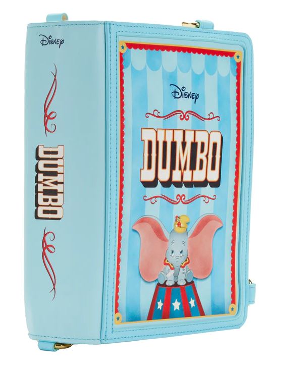 The Dumbo 1941 Book Convertible Crossbody by Blue Dog Posters is a light blue book bag featuring Disney's Dumbo. The front cover displays Dumbo the elephant in a circus setting under a marquee with the movie title "Dumbo." The spine reads "Dumbo," while decorative red details accent the edges of this versatile, convertible crossbody backpack.