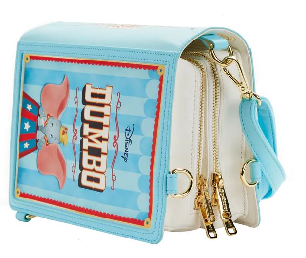 The Blue Dog Posters Dumbo 1941 Book Convertible Crossbody is a rectangular Disney handbag themed around Dumbo, crafted from vegan leather. The bag boasts a light blue trim with a vintage-style Dumbo illustration on the front and features gold-tone zippers and pulls along the sides, along with a light blue adjustable shoulder strap—a perfect accessory for any fan.