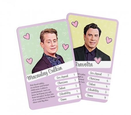 A pair of playing cards from our Hollywood Hunks Card Game by Blue Dog Posters features heart-themed backgrounds with illustrated portraits of two men. Each card lists attributes like "Sex Appeal," "Charisma," "Talent," and "Likeability" with numerical ratings, plus their names and descriptions at the bottom. Guaranteed laughs for game night!