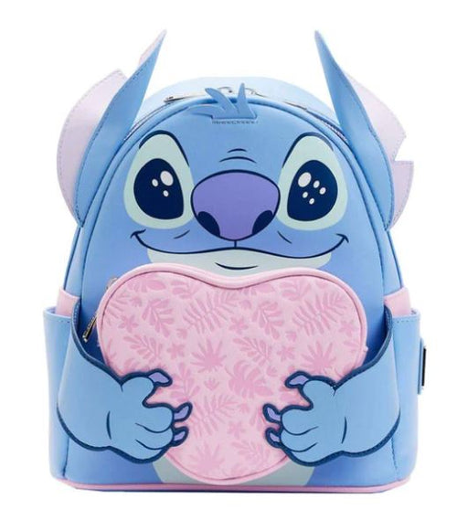 Introducing the Lilo & Stitch Heart Stitch Mini Backpack by Blue Dog Posters. Crafted from vegan leather, this mini backpack is designed to resemble the beloved character Stitch from Disney's "Lilo & Stitch." In blue and light purple hues, it features a front pouch with a pink heart adorned with floral patterns, along with Stitch's facial features, ears, and hands holding the heart.