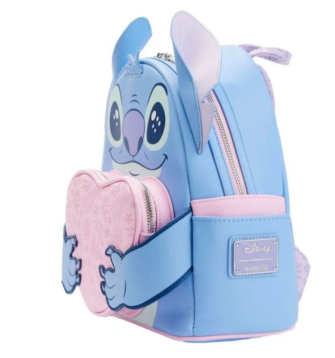 Introducing the Lilo & Stitch Heart Stitch Mini Backpack by Blue Dog Posters. This blue and pink cartoon-themed backpack features a 3D design of Stitch with large ears holding a heart. Crafted from vegan leather, it boasts a Disney Loungefly logo on the front pocket and multiple zippered compartments for all your storage needs.