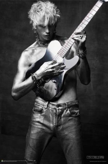 A black-and-white image of Machine Gun Kelly, shirtless with short, messy hair, playing an electric guitar. He's wearing jeans and accessories, including rings and a choker necklace. Machine Gun Kelly appears focused on his performance against a dark background—ideal for a premium gloss paper music poster from the MUS 205 brand.