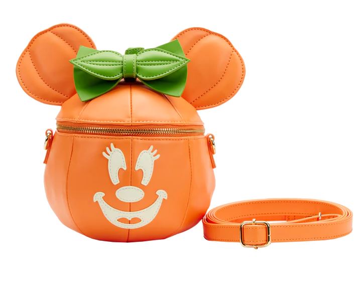 The Disney Minnie Pumpkin Face Crossbody Bag by Blue Dog Posters is an adorable, pumpkin-shaped shoulder bag. It showcases a glow face graphic, green bow on top, and mouse ears. This Loungefly creation features a gold zipper and comes with a matching orange adjustable strap, making it the perfect accessory for Halloween.