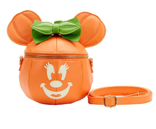 The Disney Minnie Pumpkin Face Crossbody Bag by Blue Dog Posters is an adorable, pumpkin-shaped shoulder bag. It showcases a glow face graphic, green bow on top, and mouse ears. This Loungefly creation features a gold zipper and comes with a matching orange adjustable strap, making it the perfect accessory for Halloween.