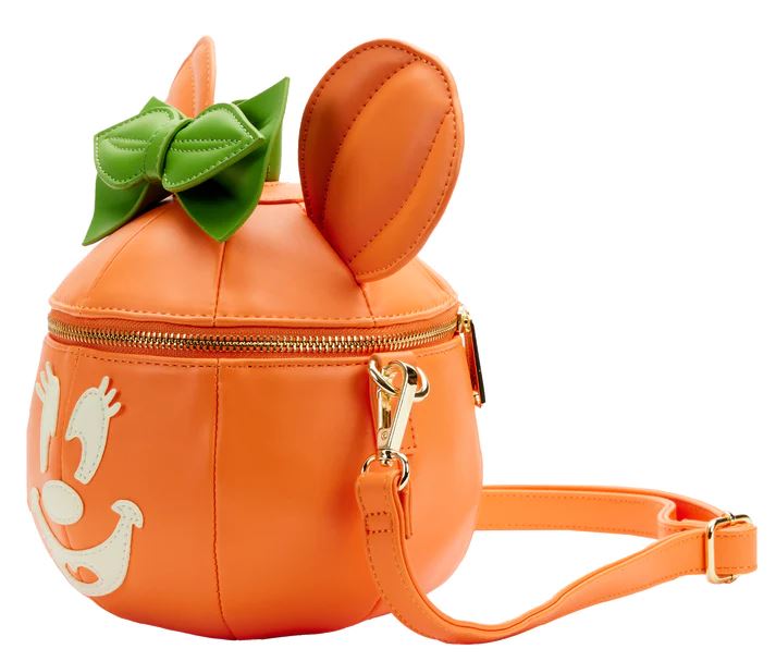 The Disney Minnie Pumpkin Face Crossbody Bag from Blue Dog Posters is an orange handbag designed to resemble a cute, smiling pumpkin with a green bow and two bunny-like ears on top. Perfect as a Halloween accessory, the bag features a zipper closure, detachable shoulder strap, and small handle.