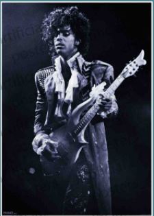 Black and white photo of a musician with curly hair playing an electric guitar. They are wearing a ruffled shirt and an ornate jacket with decorative elements. The dramatic lighting highlights their intense expression while performing on stage, captured perfectly on Prince - Purple Rain by MUS 275 premium 150gsm gloss paper.