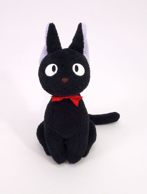 A Studio Ghibli Plush - Kikis Delivery Jiji from Blue Dog is sitting upright. This black plush cat features large white eyes, purple inner ears, and a small brown nose. Adorned with a red bow around its neck, the Jiji plush has a simple, cute design and is set against a plain white background.