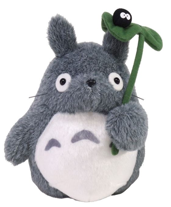 A Blue Dog Studio Ghibli Plush named "Totoro & Soot Sprite" features a grey, round creature with pointed ears, large eyes, and a white belly adorned with grey crescents. It holds a green leaf topped with a small black, fuzzy entity—evoking the beloved Big Totoro from My Neighbour Totoro.