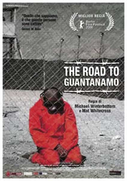 Poster for "The Road to Guantanamo." A person in an orange jumpsuit, blindfolded and wearing earmuffs, kneels inside a fenced area. Created on premium 150gsm gloss paper, the text includes the title, directors, and festival awards against a stark background. Available as an Extra Large Import Poster by IMP 057 titled "The Road to Guantanemo".