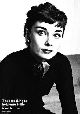 Audrey Hepburn - The Best Thing by MTV 307: A black-and-white photo of Audrey with short dark hair, expressive eyes, and a scarf, sitting on a couch. “The best thing to hold onto in life is each other.” Premium gloss paper movie icon poster.