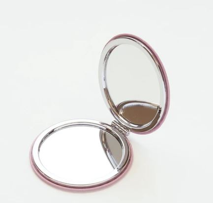 The Blue Dog Posters Round Compact Mirror Chick with Hat, a small pink mirror imported from Japan, is open to reveal two reflective surfaces against a plain white background.