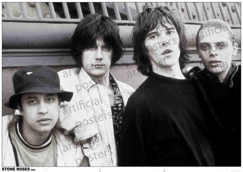 Black and white photo of four young men standing closely together. They have medium-length hair and wear casual clothes. One wears a bucket hat while another sports a patterned shirt. They stand in front of a wall with a barred window and ledge above. Text reads "The Stone Roses"—a perfect addition to any music collection or rock poster display, available from MUS 082.
