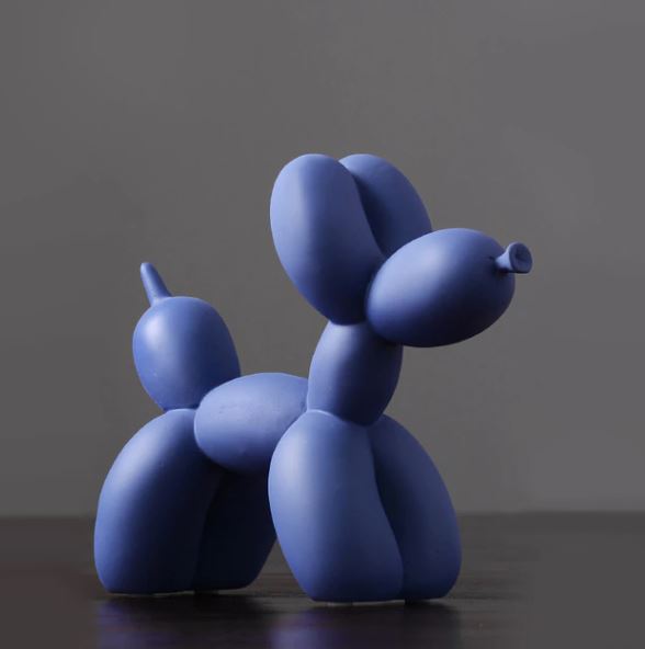 A striking blue resin balloon dog figurine by Blue Dog Posters stands against a gray background, with its smooth, rounded shapes elegantly forming the body, legs, and ears, adding a playful touch to any home décor.