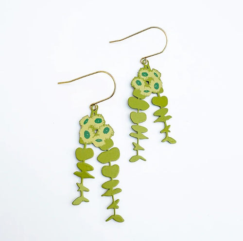 The Eucalyptus Blossom Earrings in Greens by Denz from Blue Dog Posters feature yellow-green floral tops, green accents, and leaf-like shapes on gold hooks—hypoallergenic earrings inspired by Australian flora.