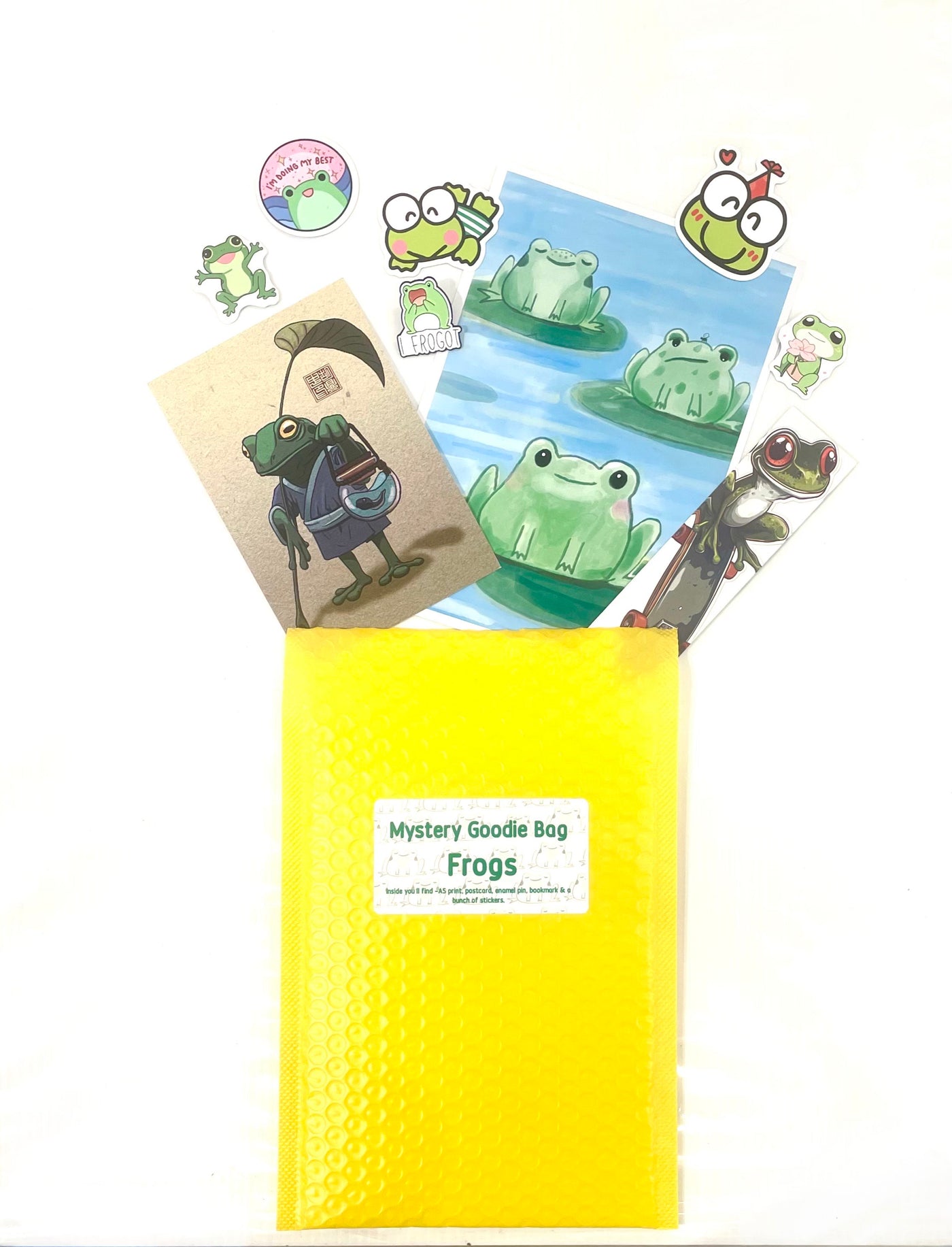 The Mystery Goodie Bag - Frogs by Blue Dog Posters sits on a white background, surrounded by colorful frog stickers, postcards, and a cute frog enamel pin—each featuring delightful frog designs.