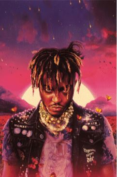 A young man with dreadlocks stands before a vivid sunset, wearing a studded denim vest and layered necklaces, butterflies swirling—a striking Juice Wrld scene by MUS 209, perfect for any hip hop poster or music collection.