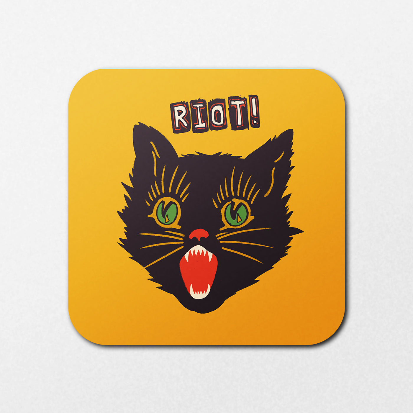 The Riot Cat Coaster by Blue Dog Posters features a stylized black cat’s head with green eyes and sharp teeth, plus “RIOT!” in bold distressed letters above on a yellow background.