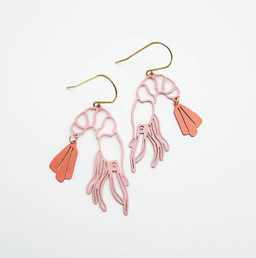 The Midi Prawn Dangles in Coral by Denz from Blue Dog Posters feature pink shrimp shapes with gold hooks and an orange tail fin, crafted from recycled stainless steel—a stylish summer Christmas accessory on a white background.