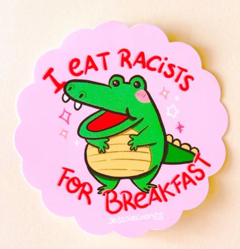 The Eat Racists Crocodile Vinyl Single Sticker by Jess Chen for Blue Dog Posters features a smiling cartoon crocodile and bold red text on pink, making it the perfect statement piece for supporting anti-racism and social justice.