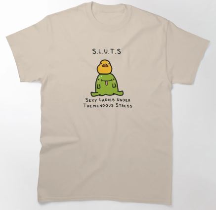 The S.L.U.T.S T-shirt NAT LGE from Blue Dog Posters showcases a distinctive design with an illustration of a small figure donning a green outfit and an orange head. The text "S.L.U.T.S" appears above the figure, while "Sexy Ladies Under Tremendous Stress" is written below. This striking beige tee is guaranteed to attract attention.
