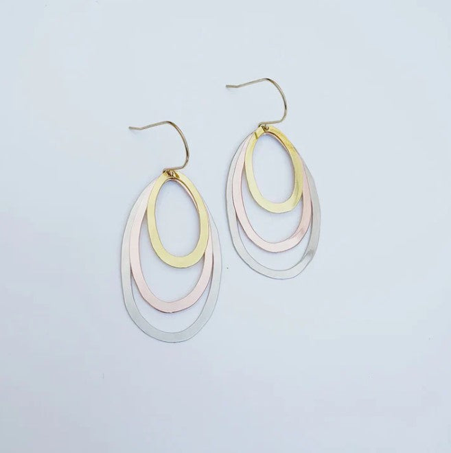 The Midi Triple Oval Earrings Mixed Metals by Denz from Blue Dog Posters feature three overlapping ovals in gold, rose gold, and silver tones, crafted from recycled stainless steel and shown on a plain white background.