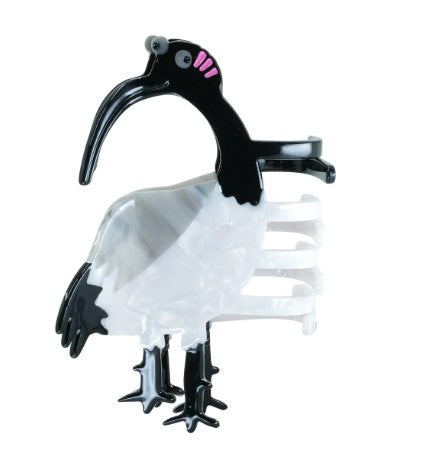 The Ibis Bin Chicken Hair Claw by Blue Dog Posters is a plant-based acetate hair clip shaped like a black and white ibis, featuring pink blush near the eye plus stylized legs and beak for a sustainable, unique accessory.