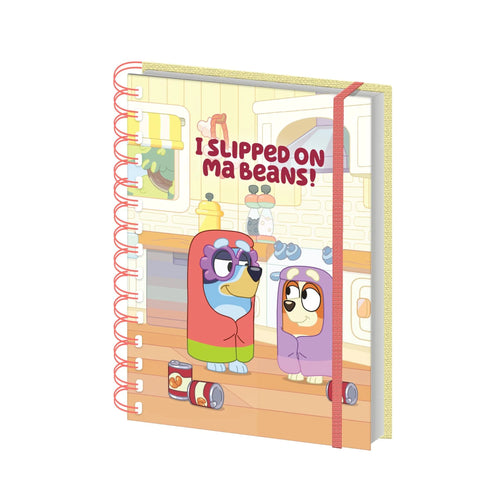 The Bluey - Grannies Wiro Notebook by Blue Dog Posters is an A5 spiral notebook with a cartoon bean-themed Bluey cover, “I SLIPPED ON MA BEANS!” text, red spiral, and elastic strap. Official Bluey merchandise.