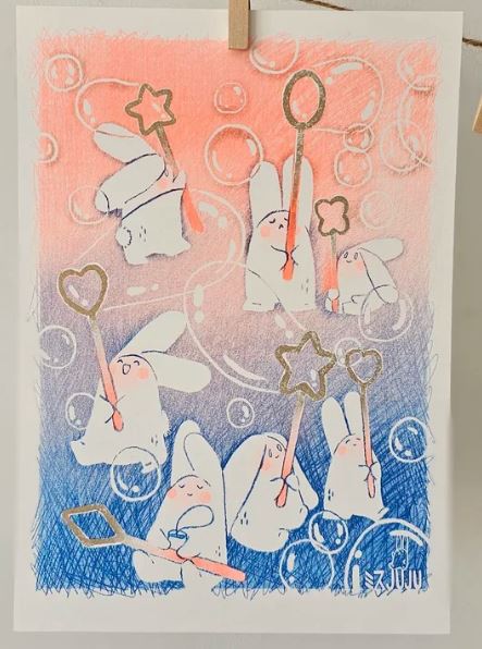 The Bunny Bubbles Riso Print by Misu Juju from Blue Dog Posters features cute white bunnies with bubble wands on a pink and blue gradient A4 background, creating a whimsical vibe—ideal for Mohawk Superfine paper.