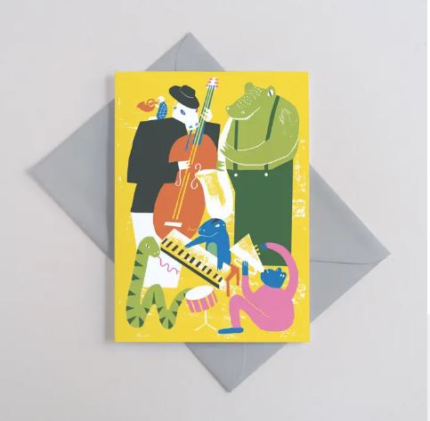 The Jazzy Reptiles Greeting Card by Blue Dog Posters features colorful litho-printed animal musicians on a bright yellow, FSC certified card—designed by Printer Johnson.