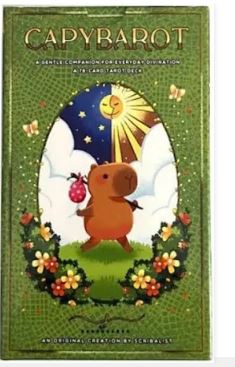 The Capybara Tarot Cards by Blue Dog Posters come in a box showing a cartoon capybara with a bundle in a flower-filled field, sun and moon above, framed by a green border—an ideal pick for Capybara Tarot deck fans.