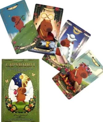 Five illustrated Capybara Tarot Cards by Blue Dog Posters, each featuring capybaras in whimsical scenes and costumes, are shown above a decorative box. This playful deck is colorful and full of charm.
