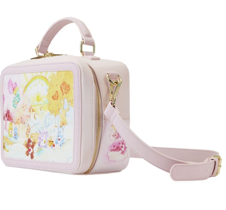 A charming crossbody by Blue Dog Posters, the Care Bears & Cousins Lunchbox Crossbody is designed in pastel pink vegan leather and features a detachable strap with gold-tone hardware. The front is adorned with a delightful illustration of cute animals in a whimsical forest under a sunny sky, capturing the playful essence reminiscent of Loungefly Care Bears designs.