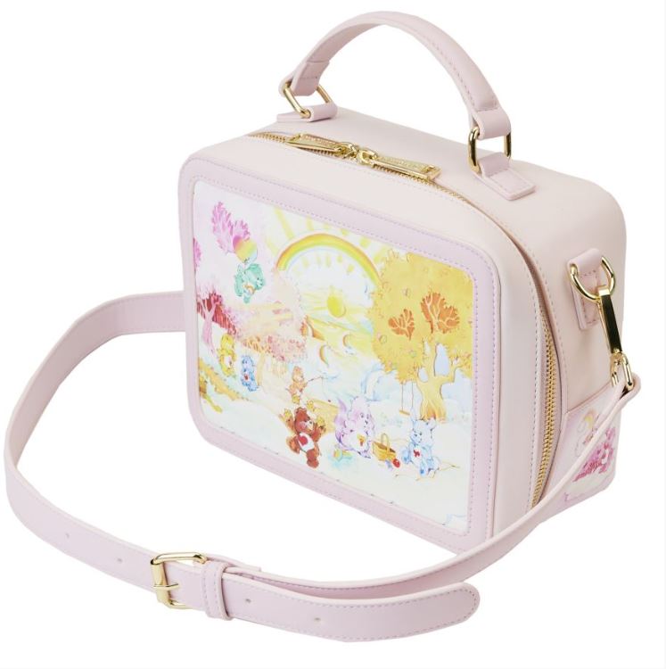 This Care Bears & Cousins Lunchbox Crossbody by Blue Dog Posters, crafted from pastel pink vegan leather, boasts a detachable strap and a whimsical illustration of colorful animals in a sunlit landscape. Its playful design captures the cheerful charm reminiscent of the Loungefly Care Bears theme.