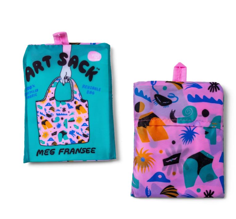 Two folded Cheeky Art Sack bags by Blue Dog Posters are shown: the left is teal with "Art Sack" text, tote illustration, and colorful shapes; the right is pink with abstract patterns. Both have pink hanging loops.