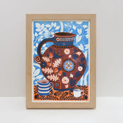 The "Cider Jug A4 Riso Print" by Vicki Johnson from Blue Dog Posters features a bold jug with leaf and geometric patterns, a striped mug, and a white cup on a blue botanical backdrop, printed on FSC certified paper.